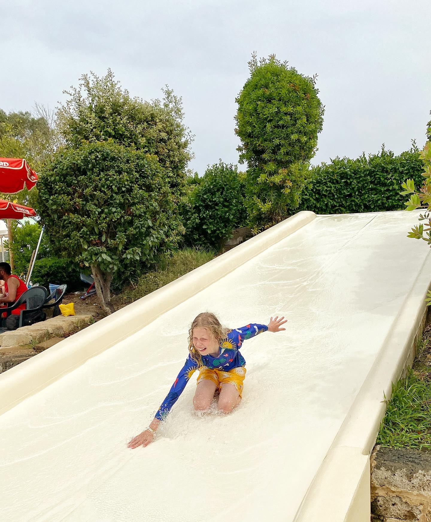 Child sliding down a water slide