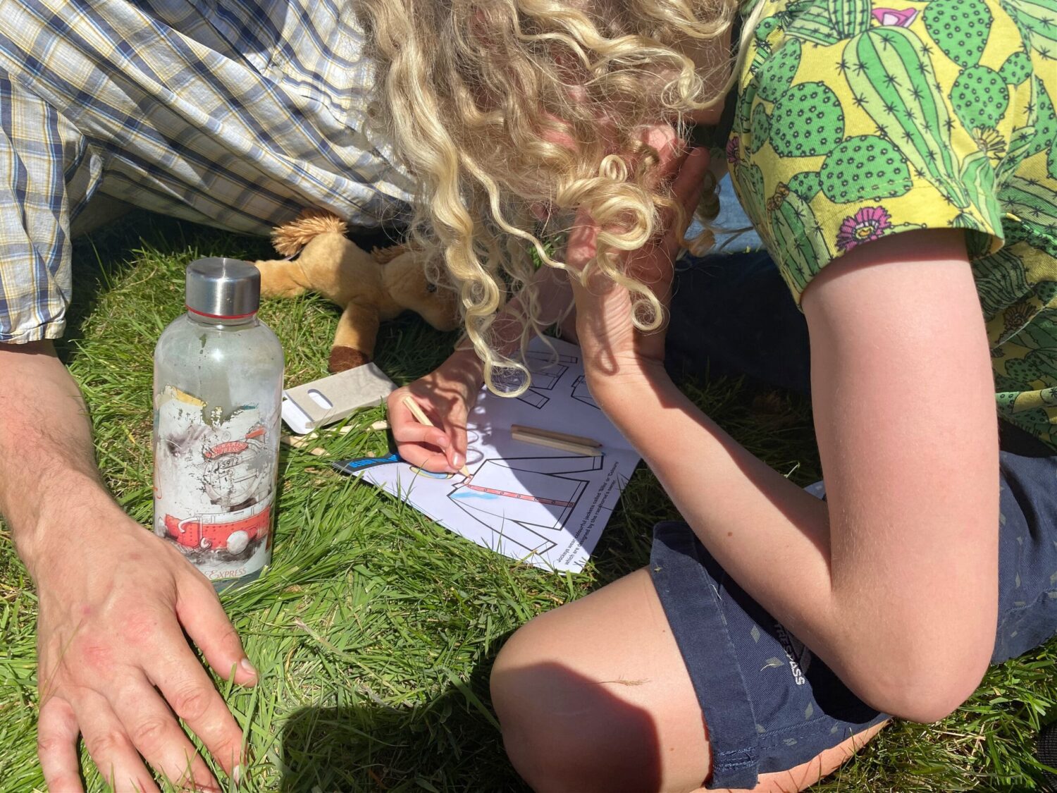 Child colouring in jockey jersey at the races