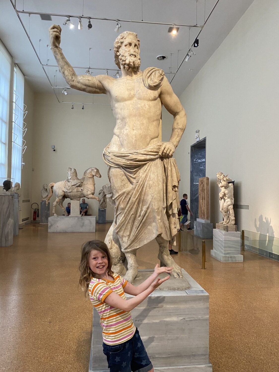 Child with statue of Poseidon or Zeus