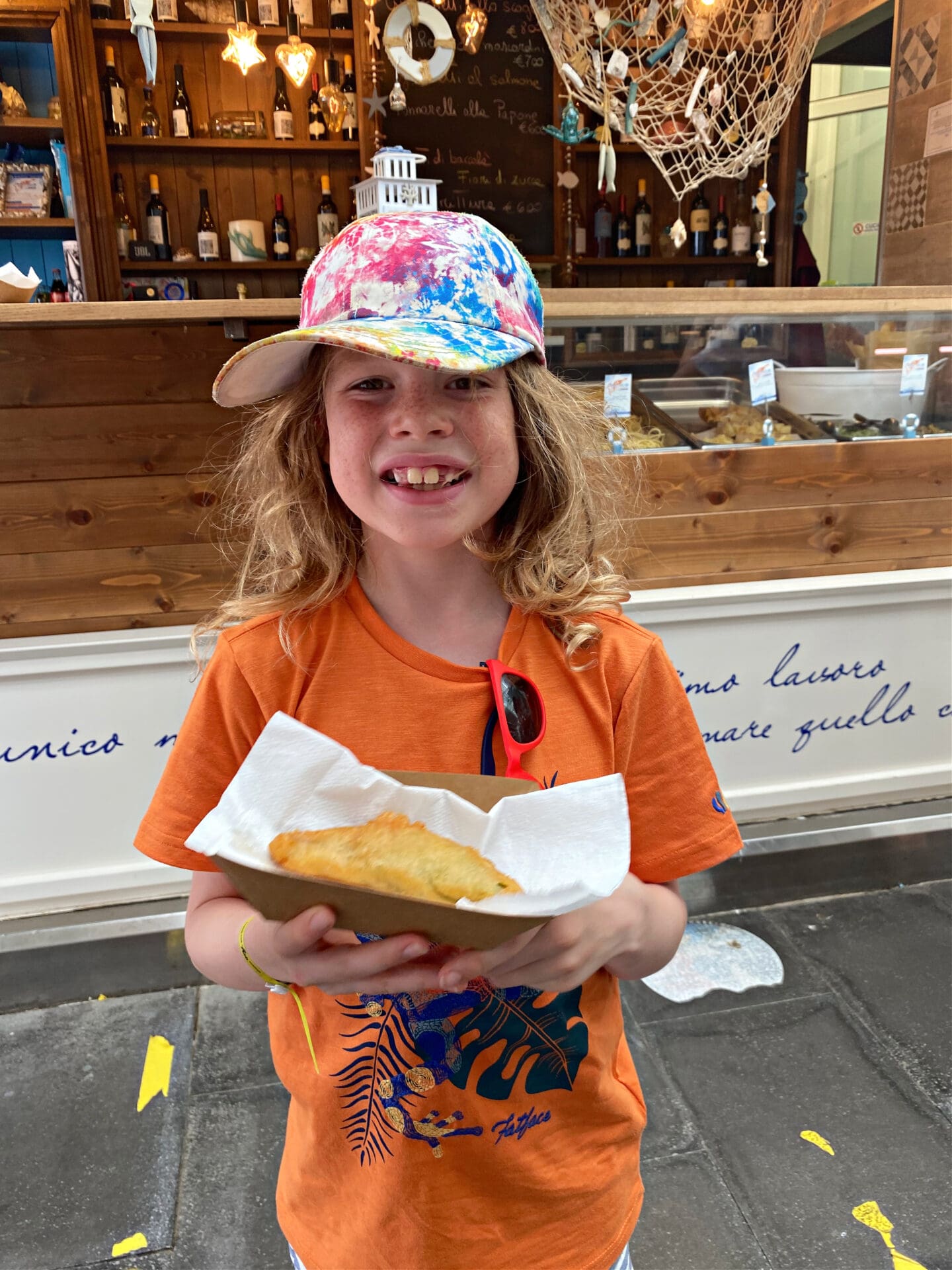 Child with fried courgette flower