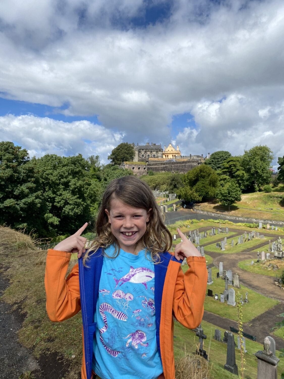 Child in front of graveyard and Stirling castle