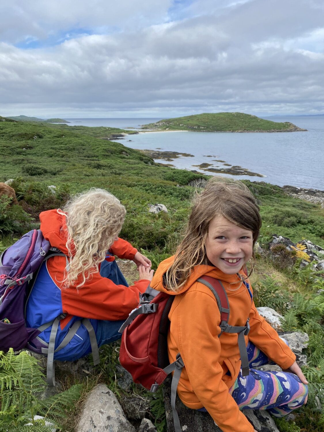 Children on hill on the island of Gigha looking at the sea