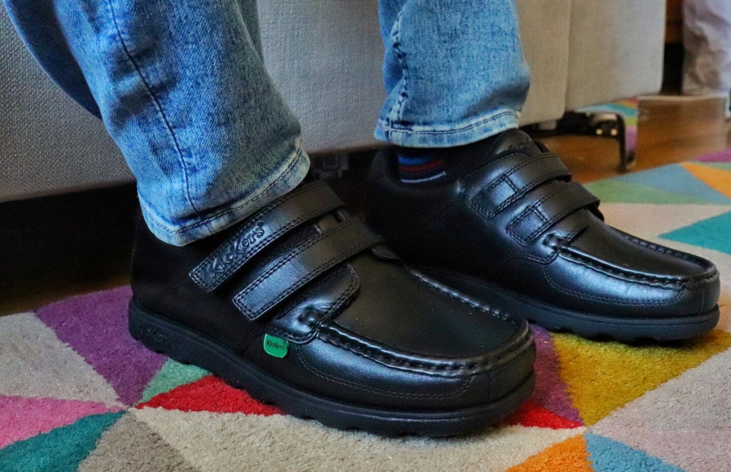 Child wearing black kickers shoes