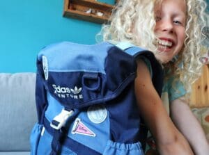 Child with blue Adidas Disney backpack
