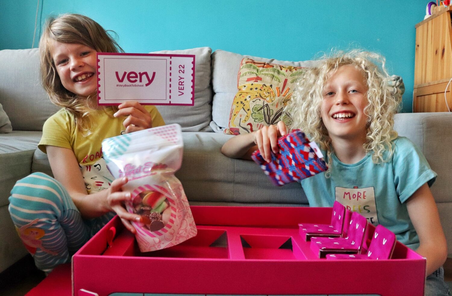 children unpacking pink school bus