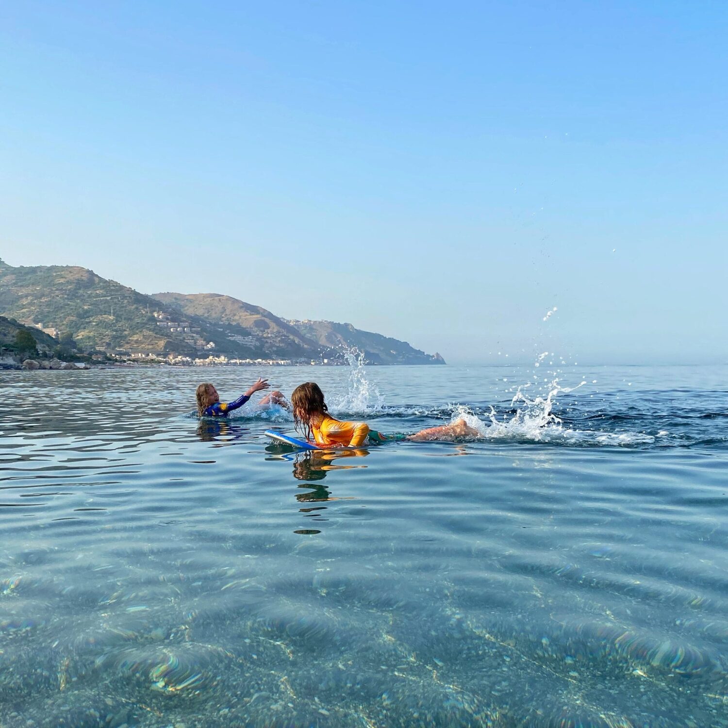 Children swimming in the sea of Sicily Mediterranean