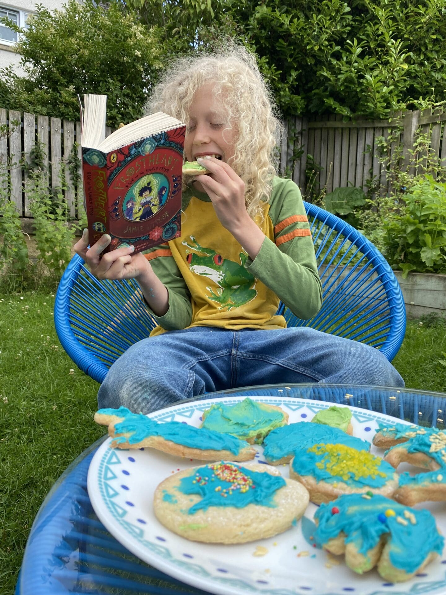 Child reading book with biscuits