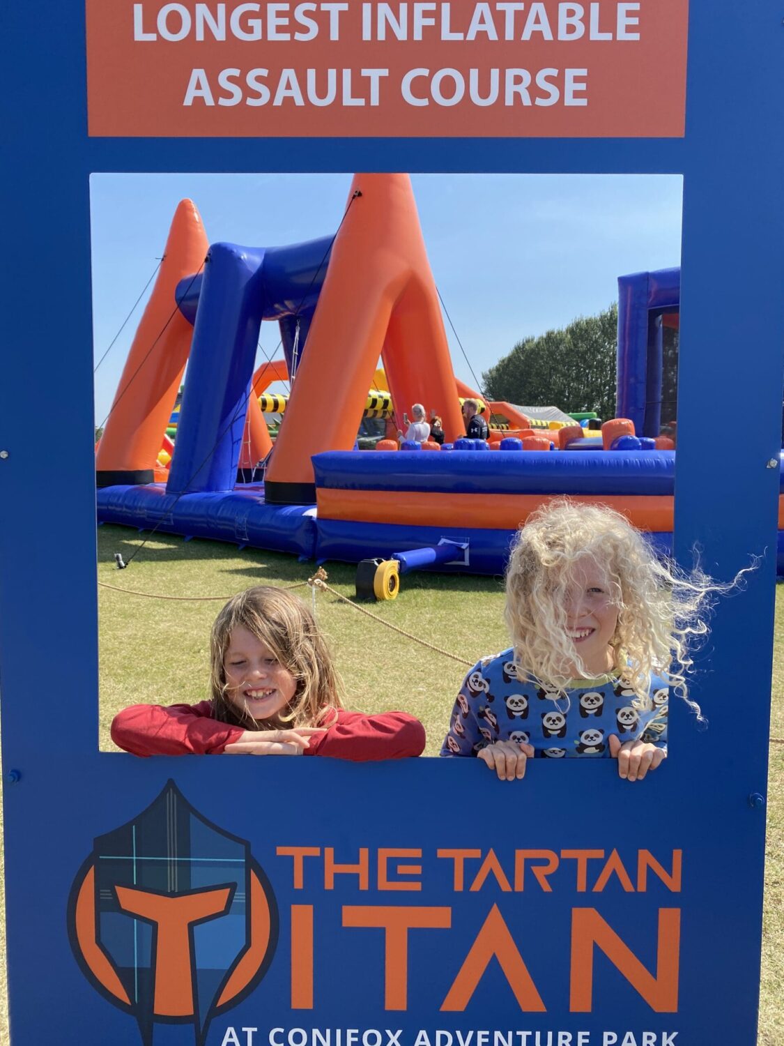 Children at a giant outdoor inflatable course