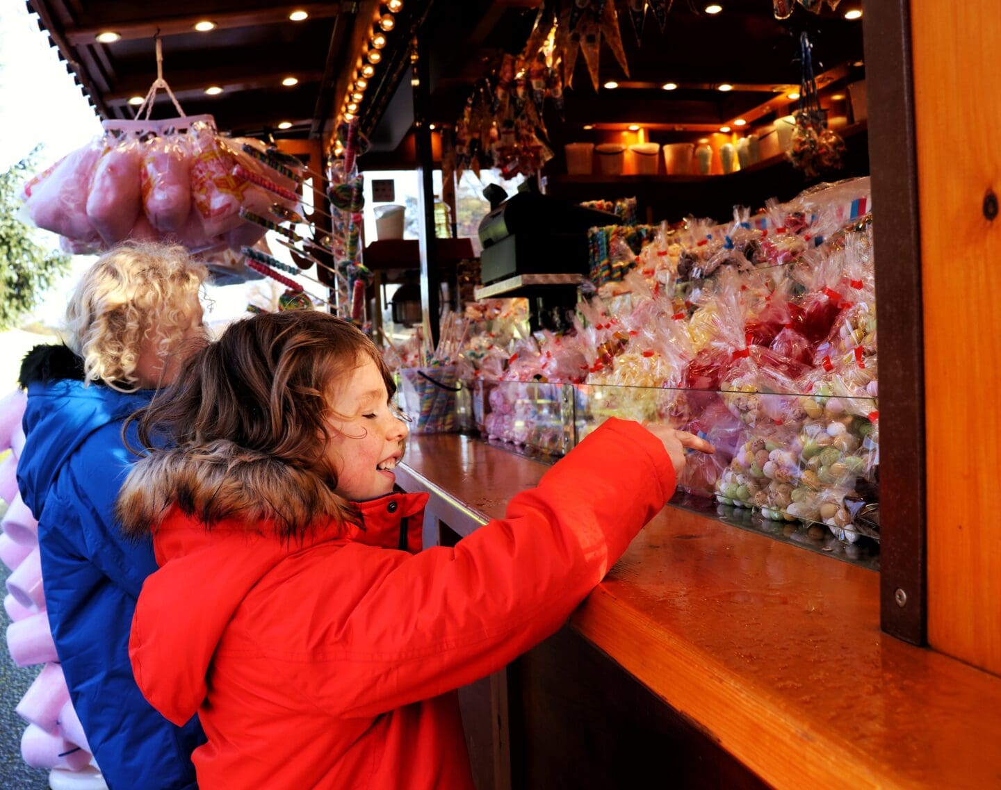 Children choosing sweets at Christmas market stall