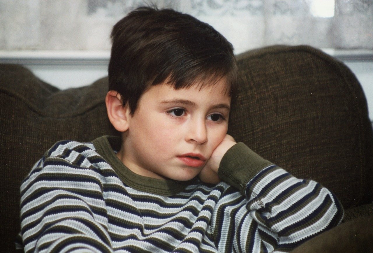 Child watching television on sofa