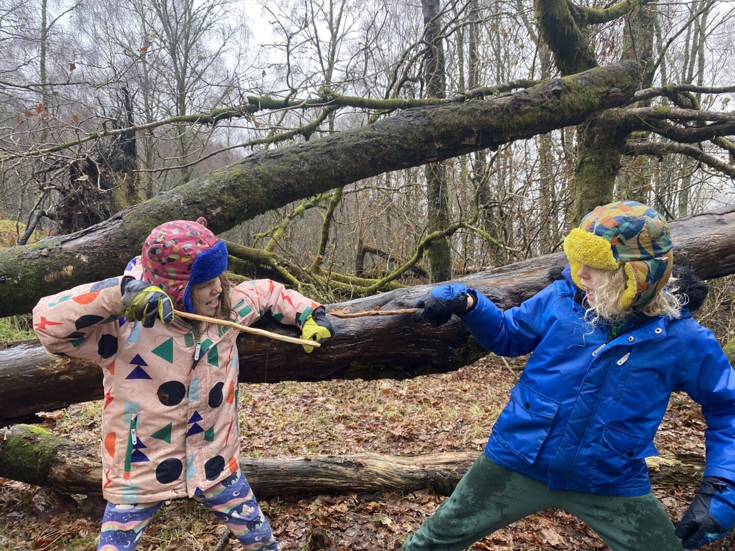 Children with homemade wands in the woods