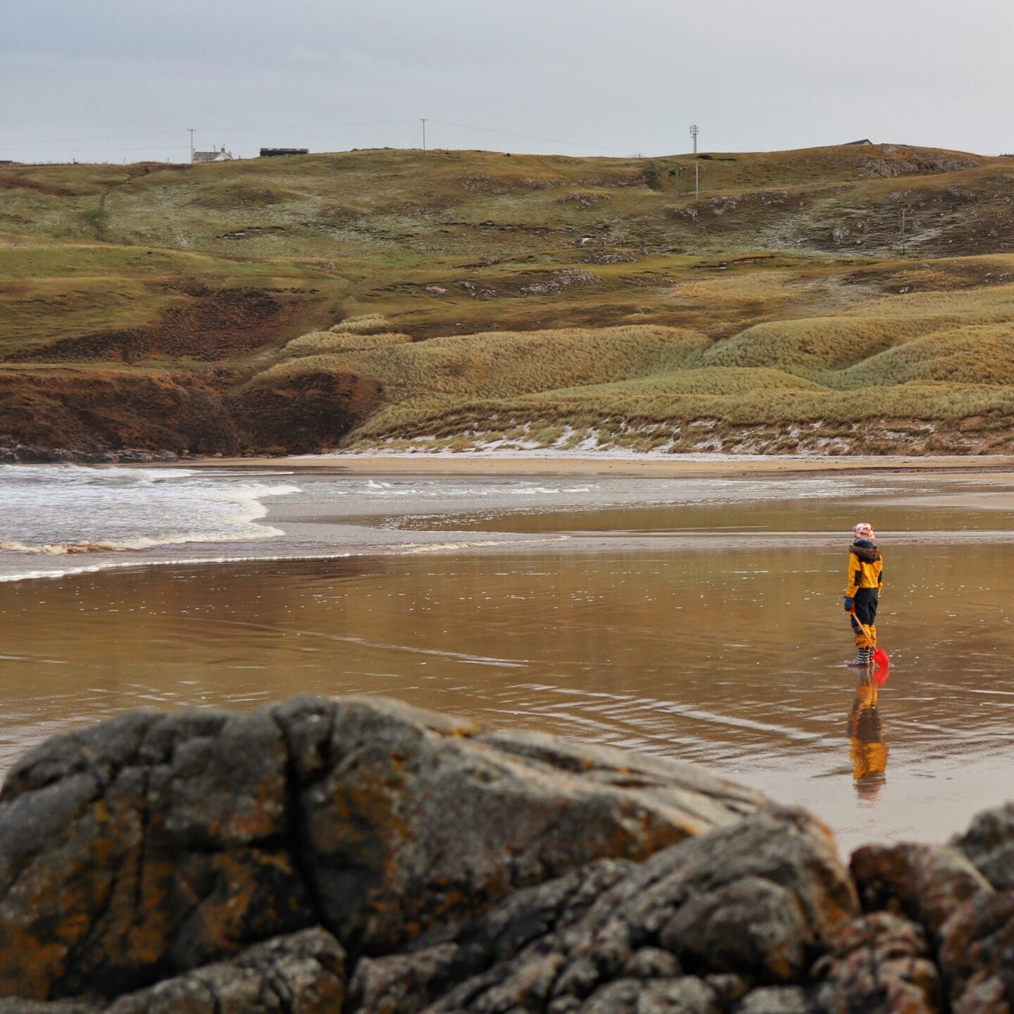 Child on beach in winter