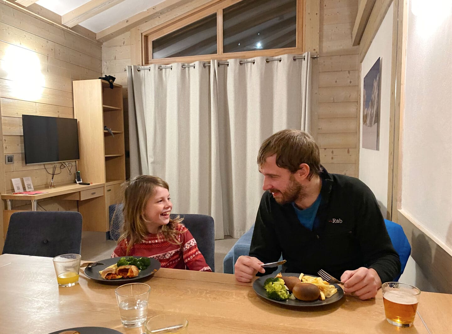 Child and father having dinner in apartment
