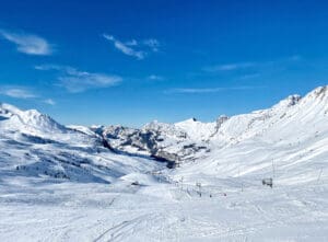 Snow covered french alps and ski run