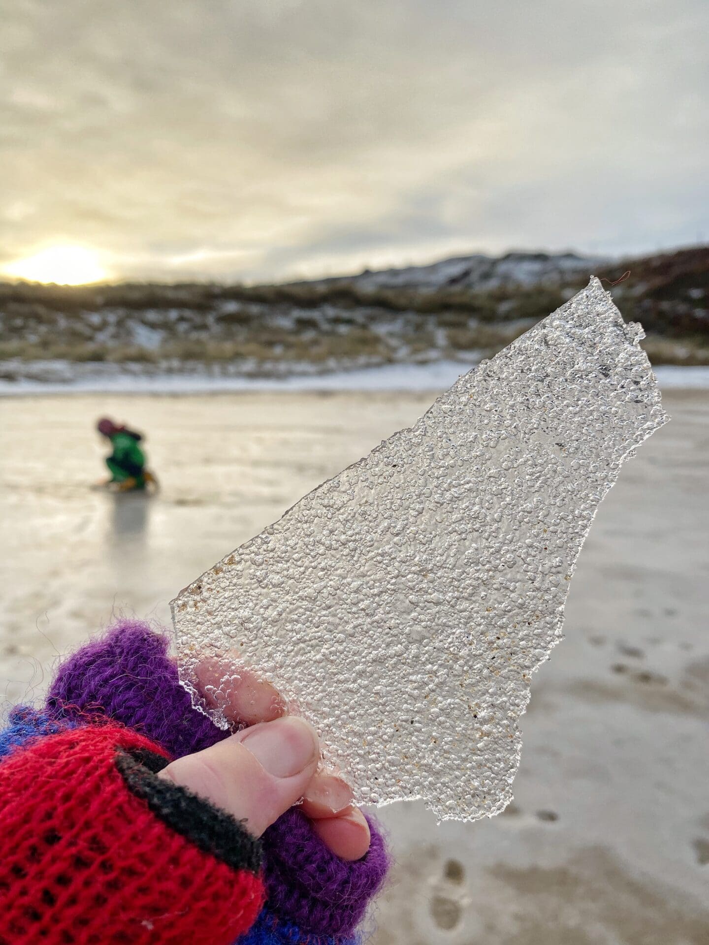 Hand holding up sand ice