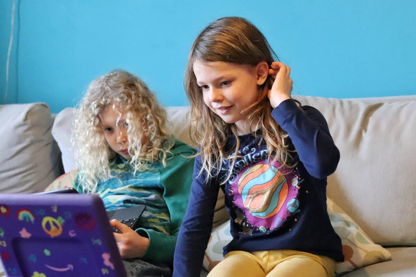 Children looking at tablet for online course