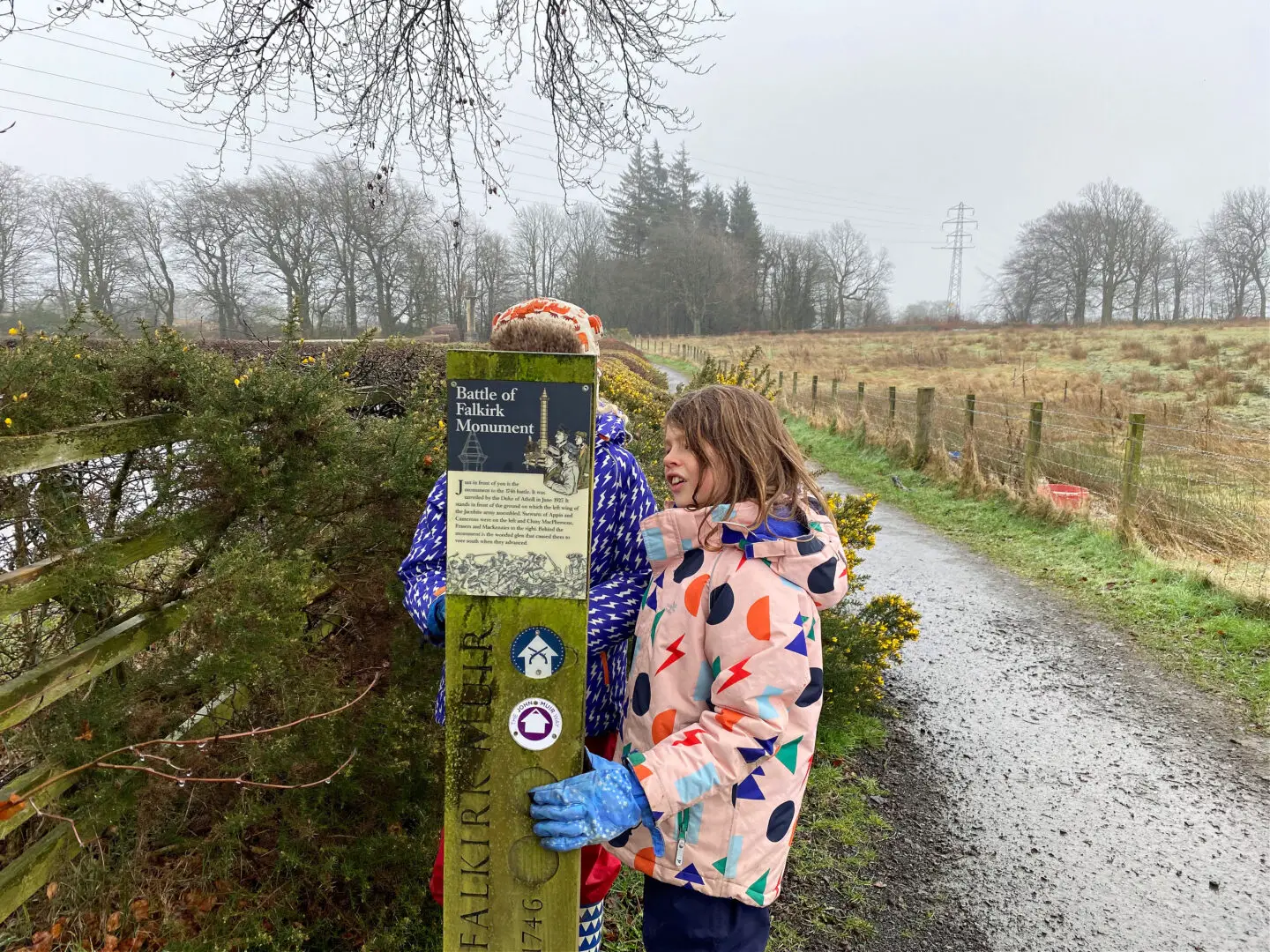 Children reading Falkirk trail sign