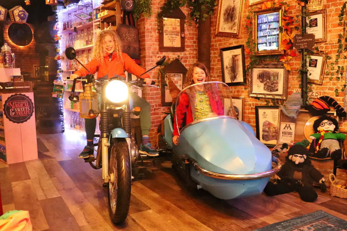 Children in Harris’s motorbike The Lonely Broomstick wizard shop