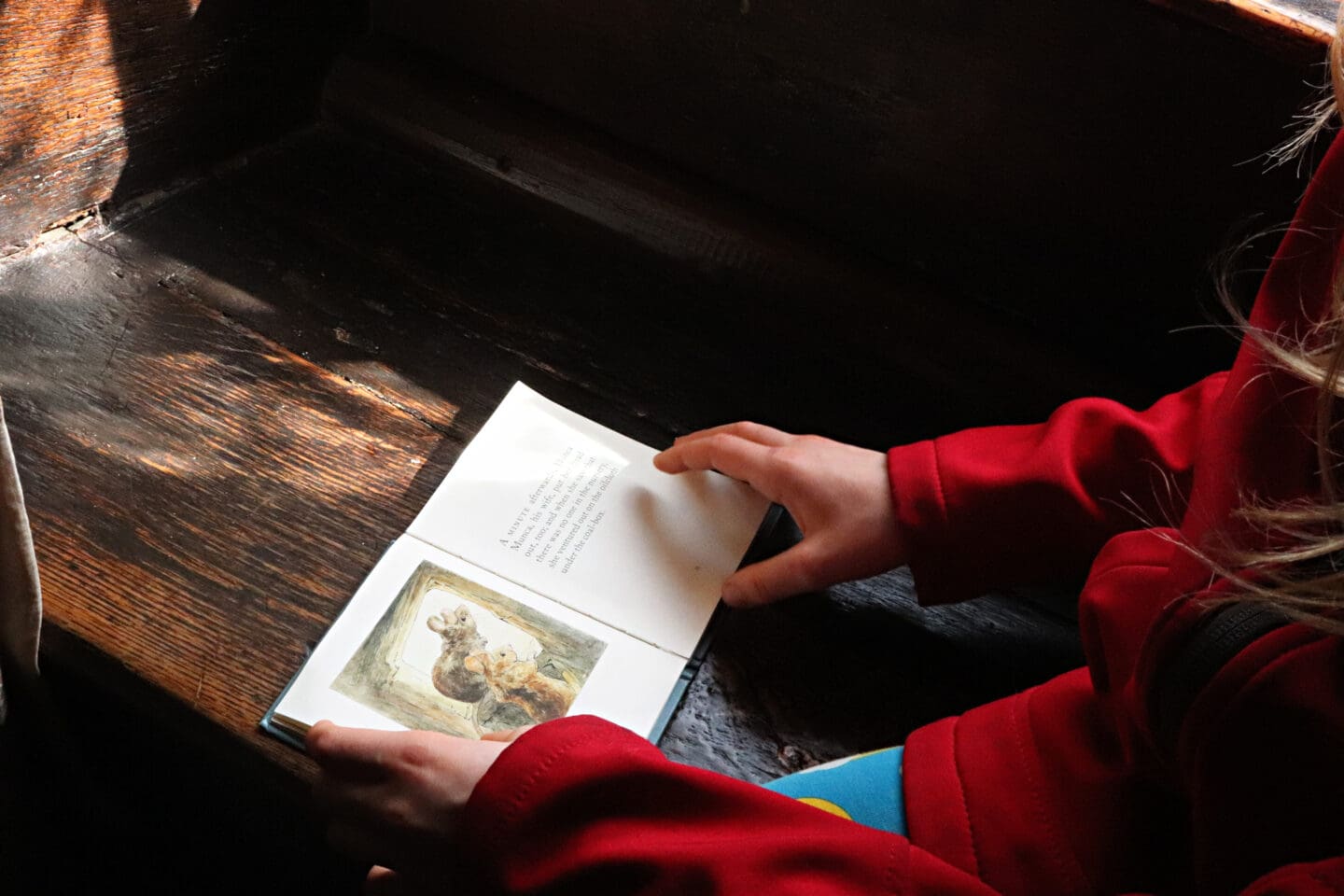 Child reading Samuel Whiskers Beatrix Potters book at Hill Top house