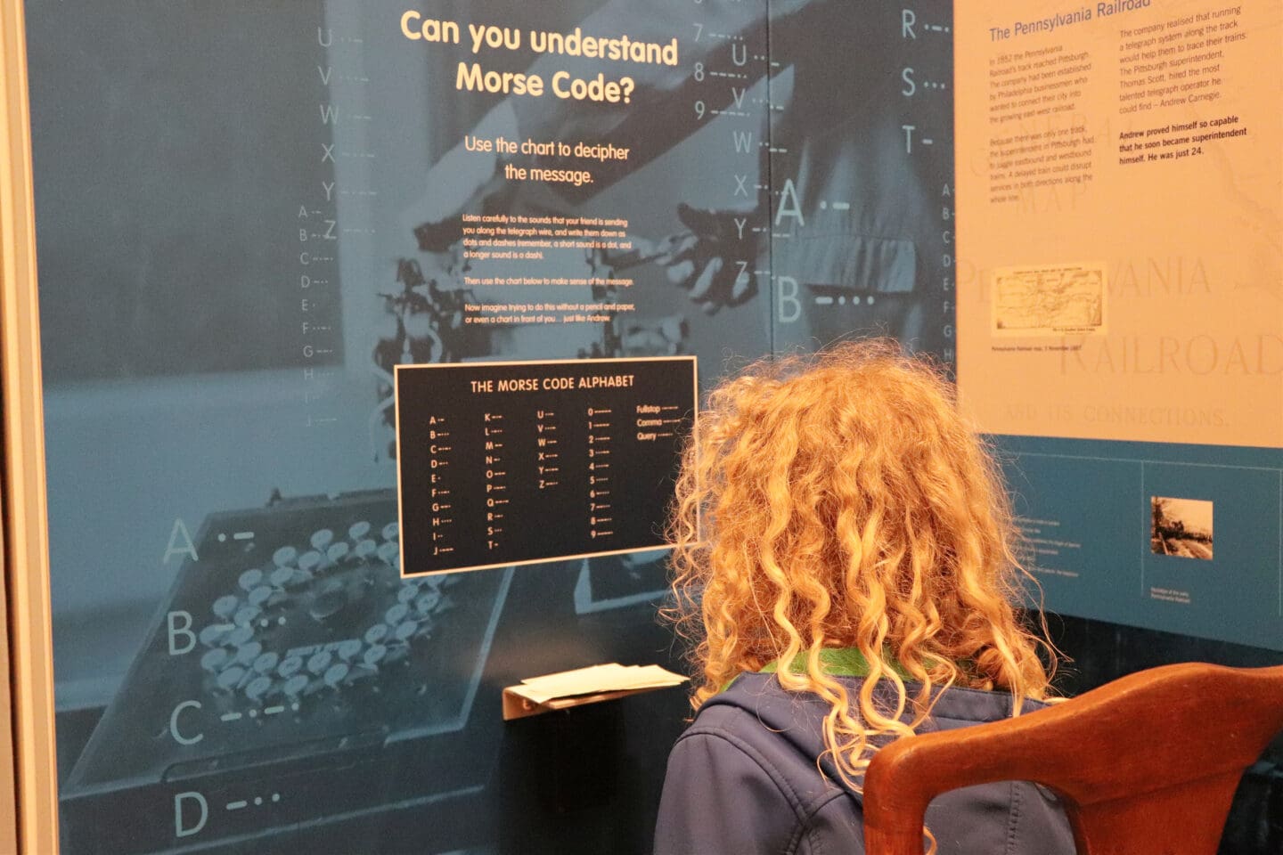 Child learning morse code at Carnegie birthplace museum