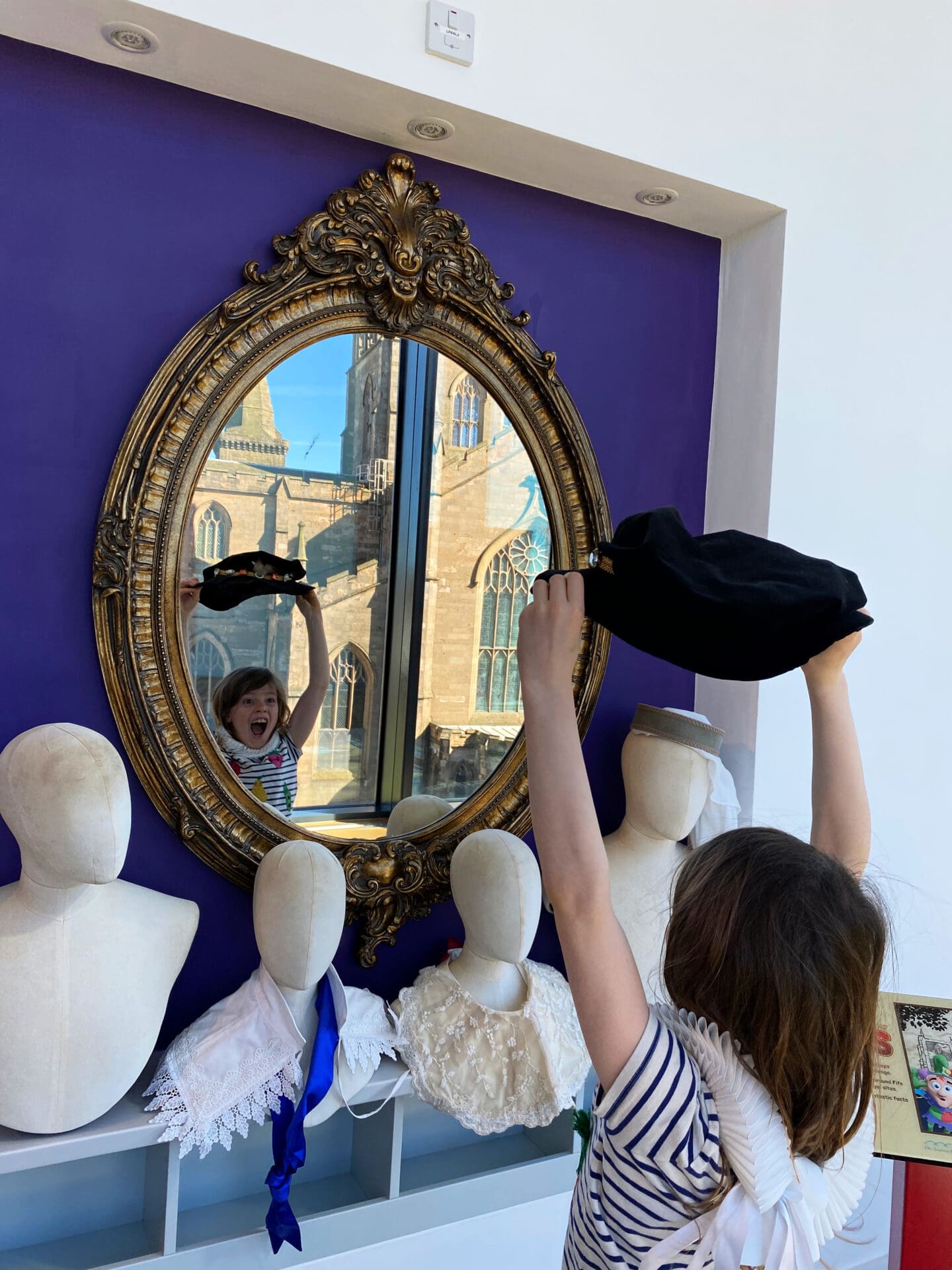Child dressing up with Abbey reflected