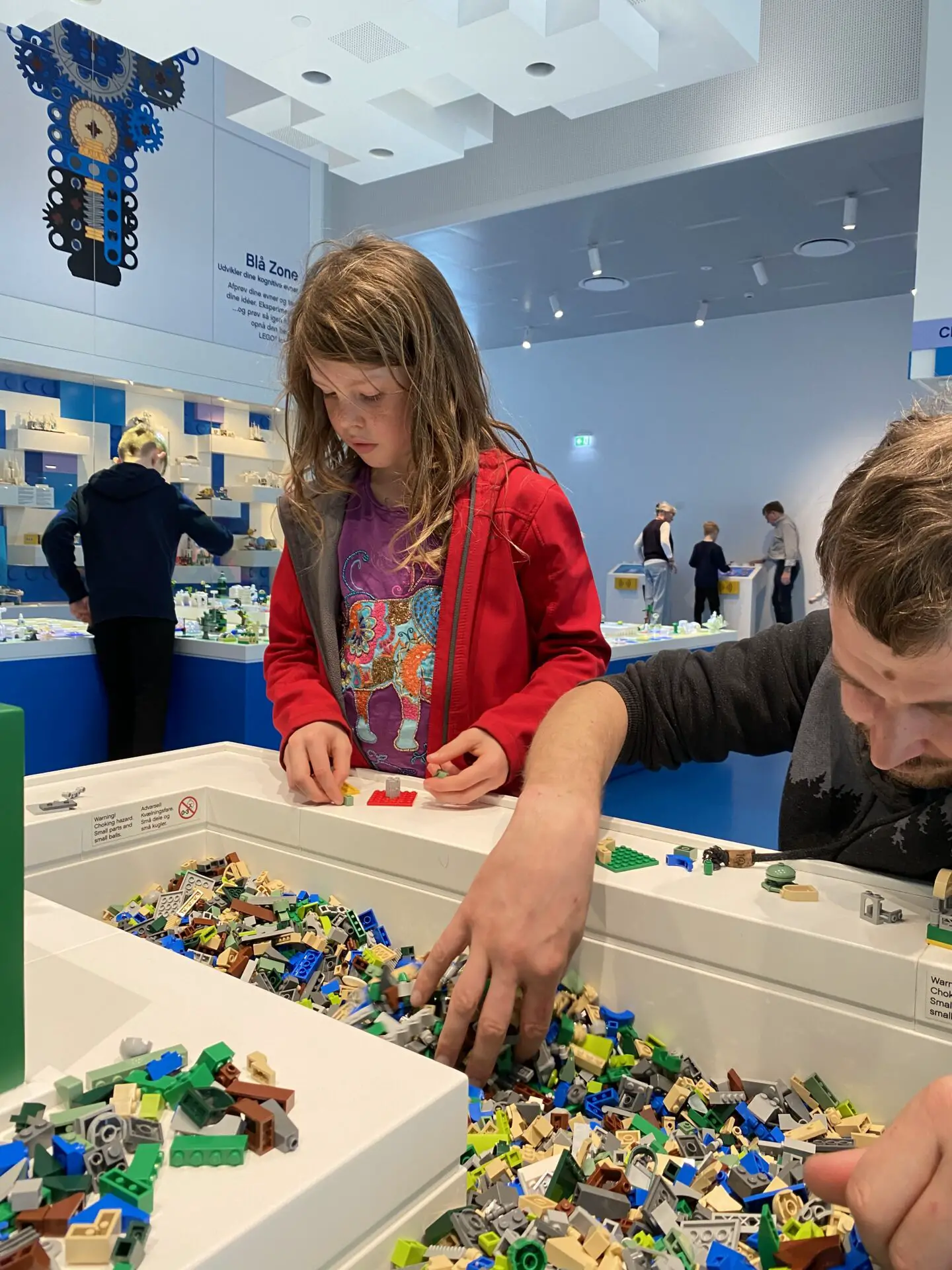 Child and father building Lego at Lego House Billund