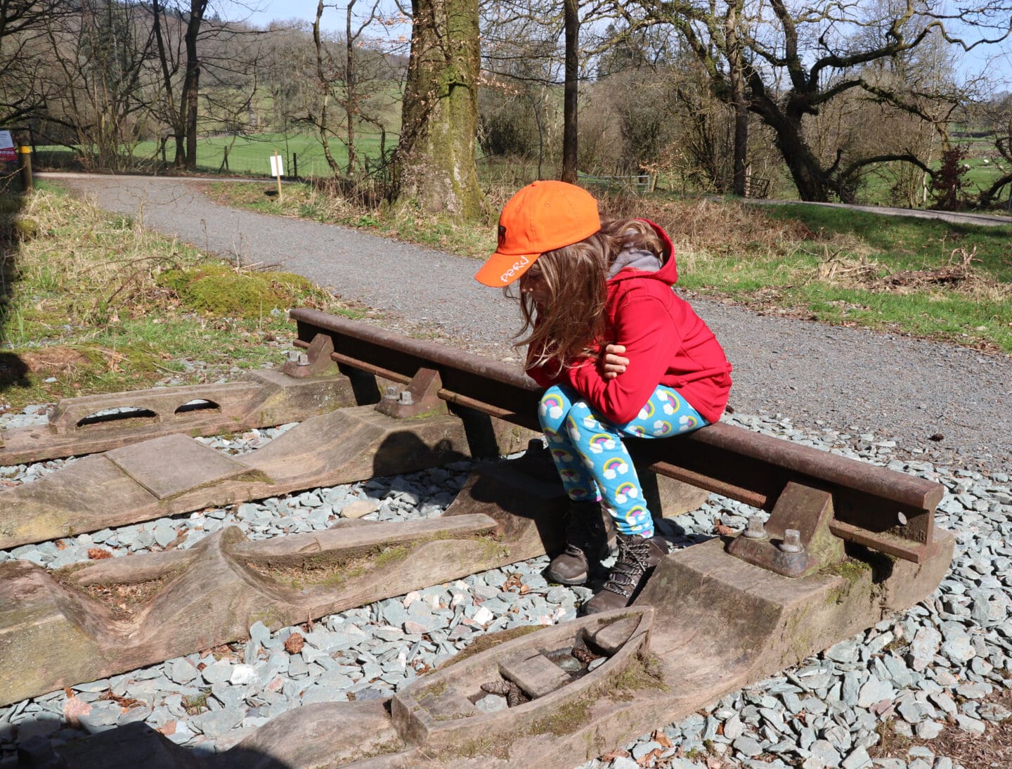 Child beside sculpture at Grizedale
