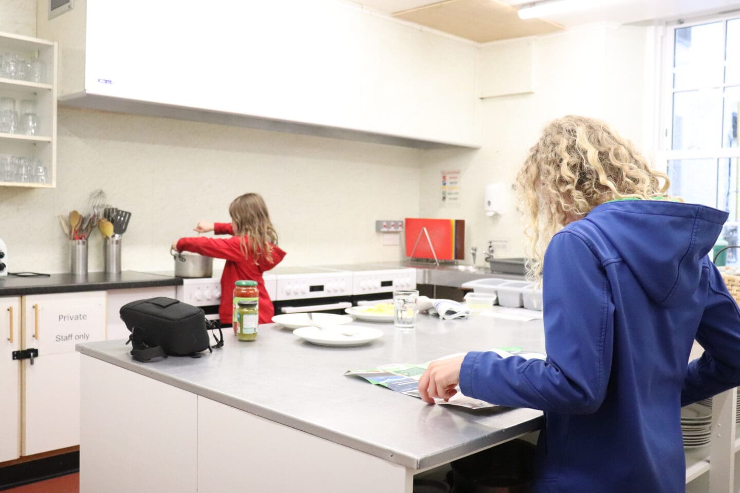 Children cooking dinner at a youth hostel