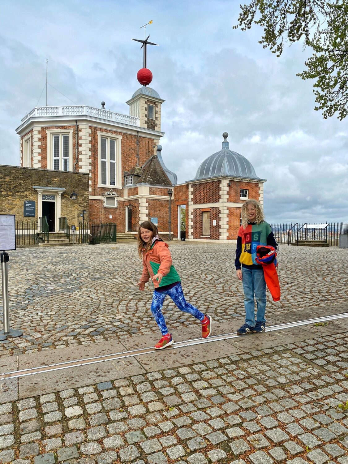 Children standing on the prime meridian