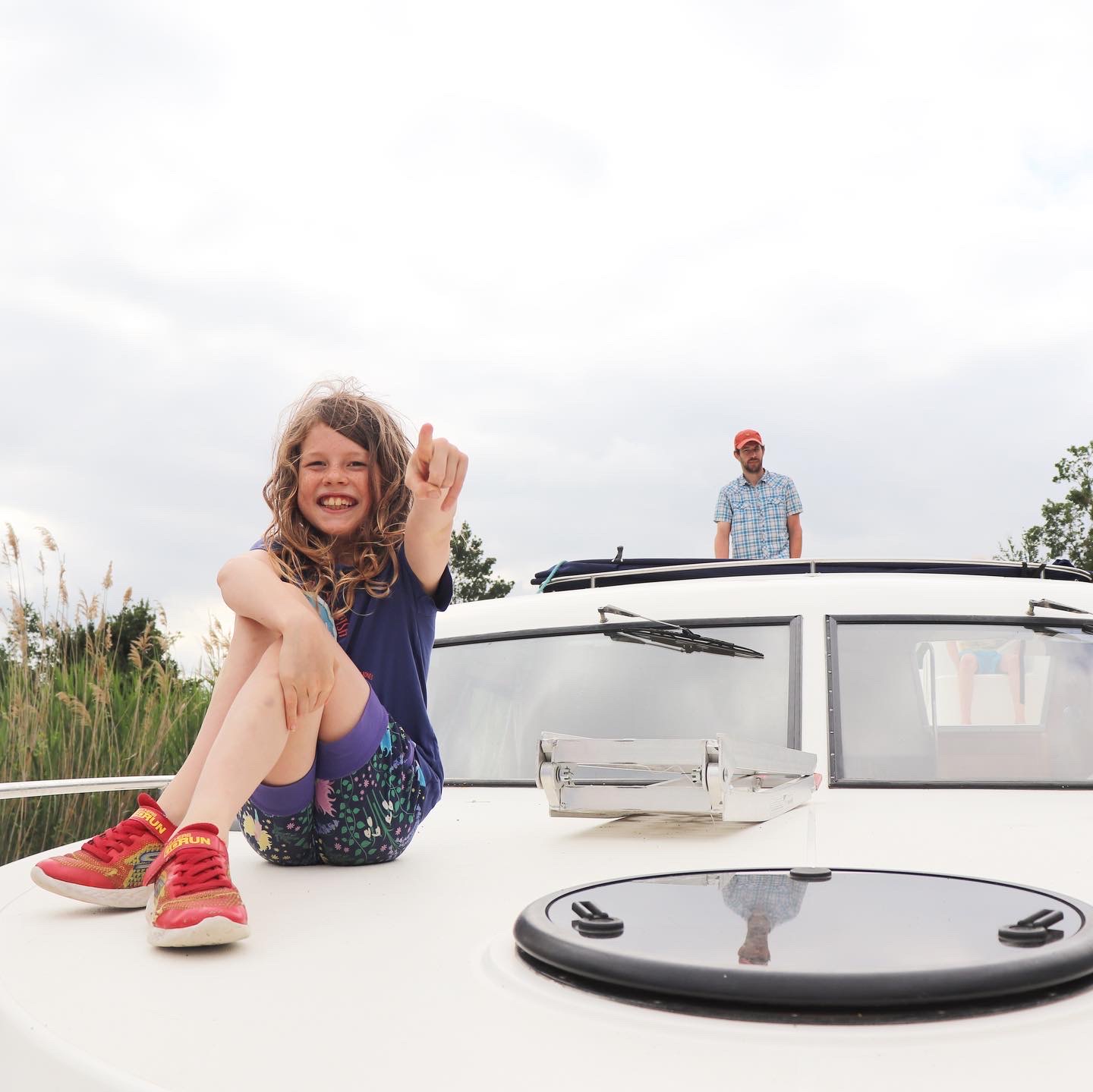 Child on front of boat on canal