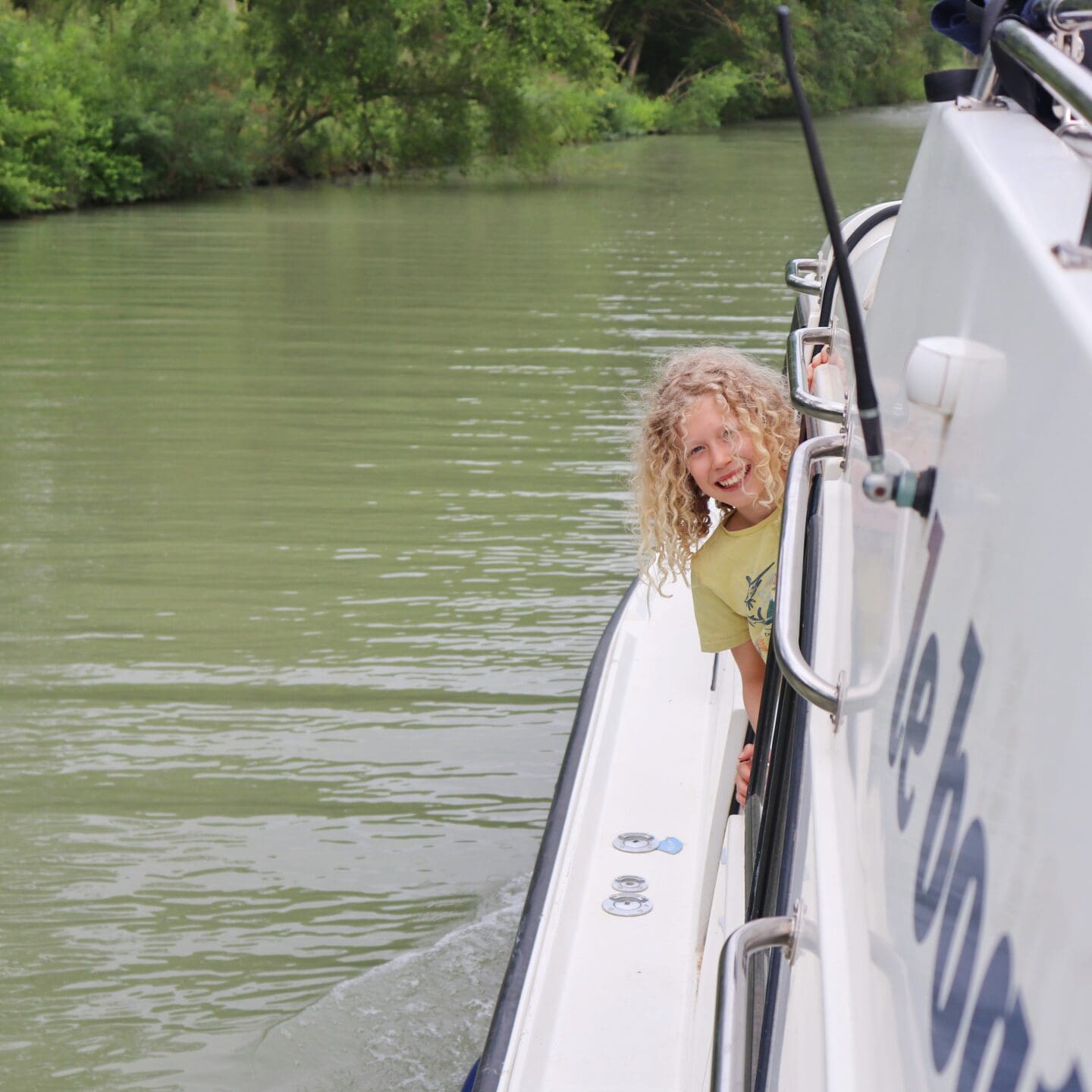 Child looking out the side of a boat