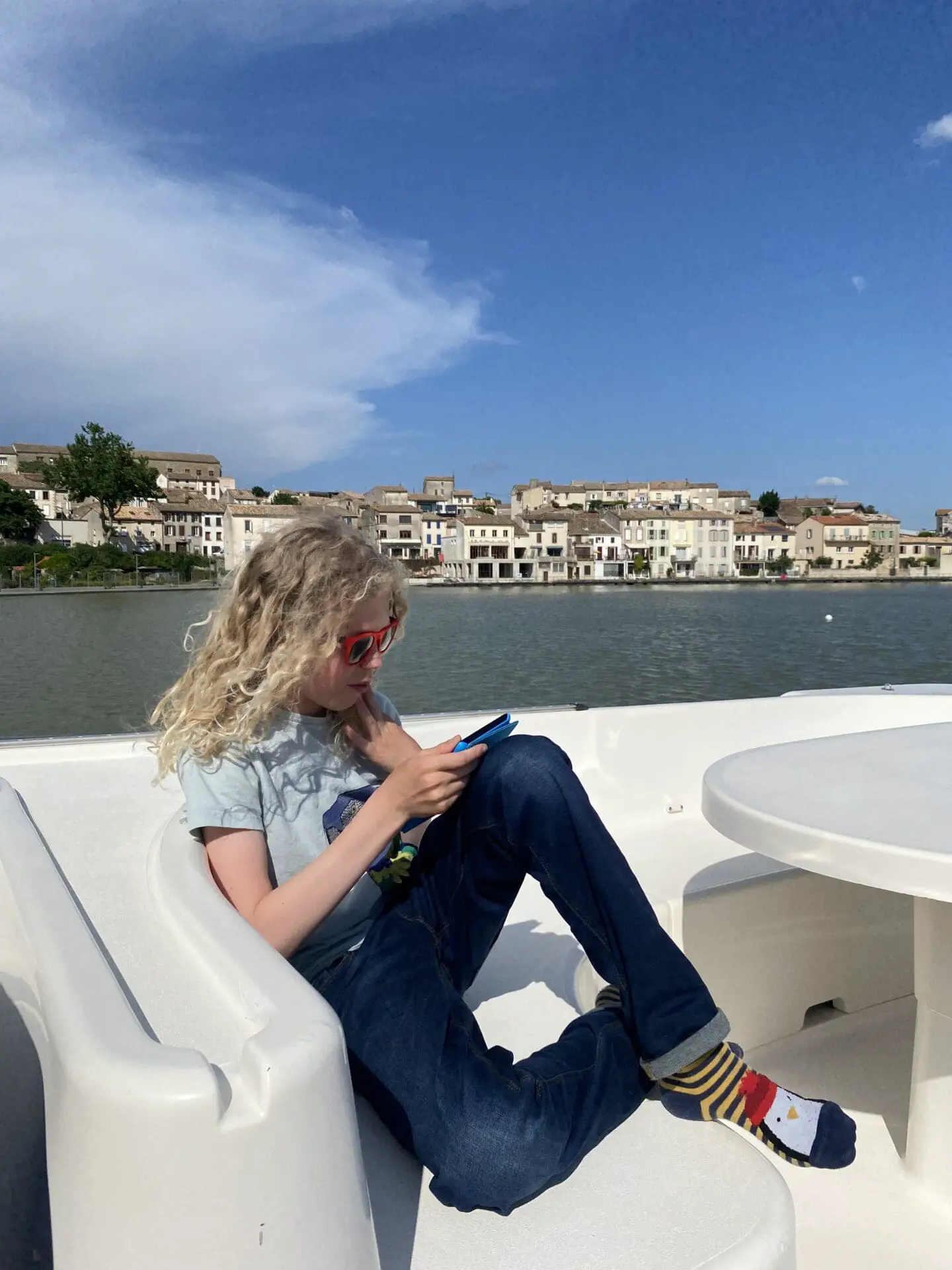 Child reading on canal boat Castelnaudary