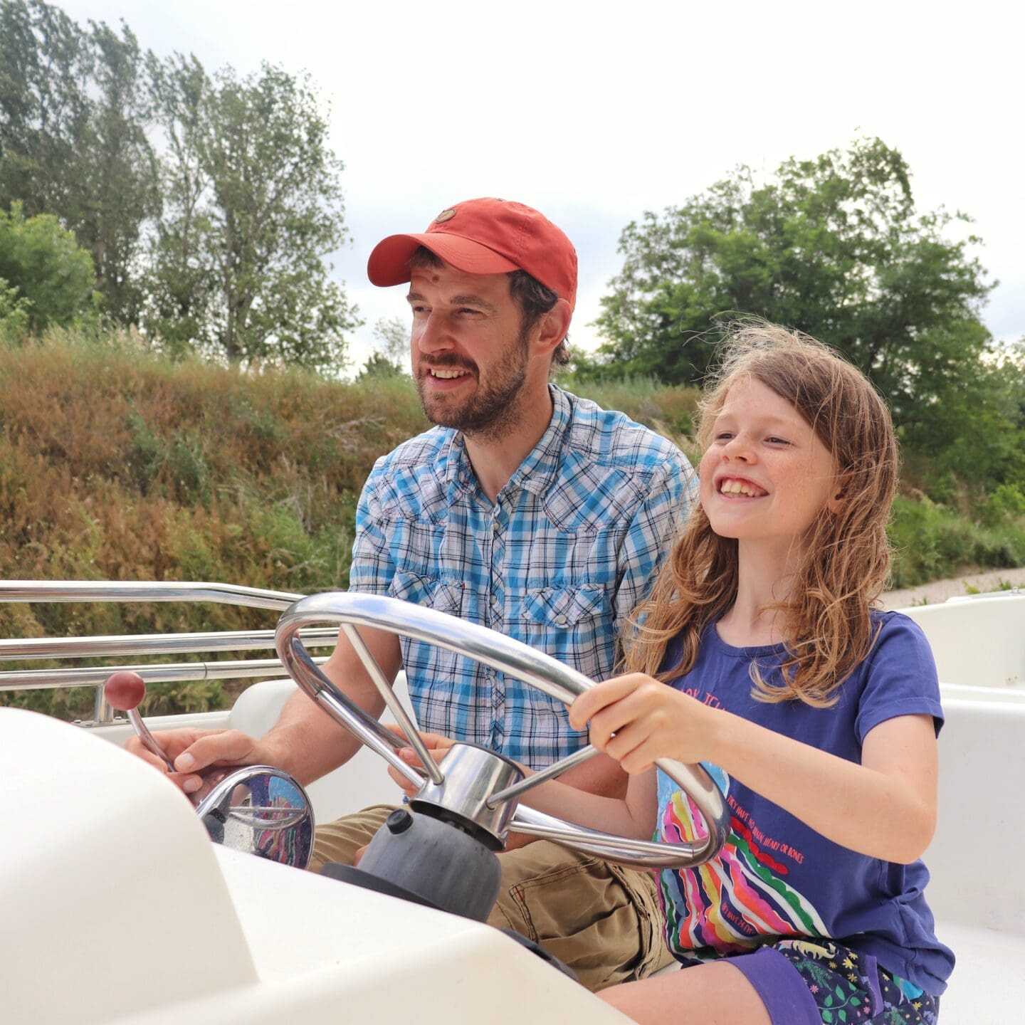Child helping drive boat