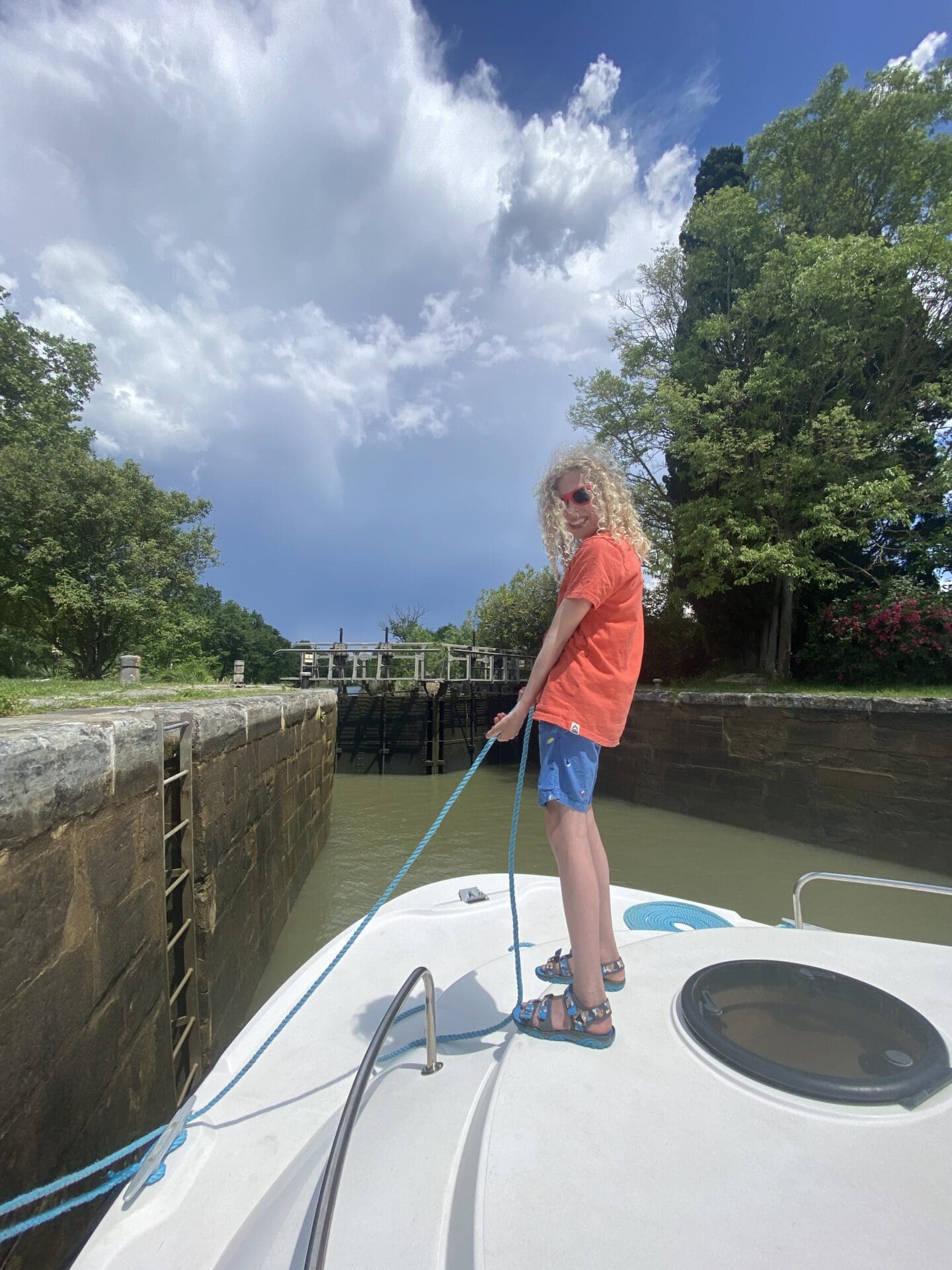 Child holding tope inside canal lock