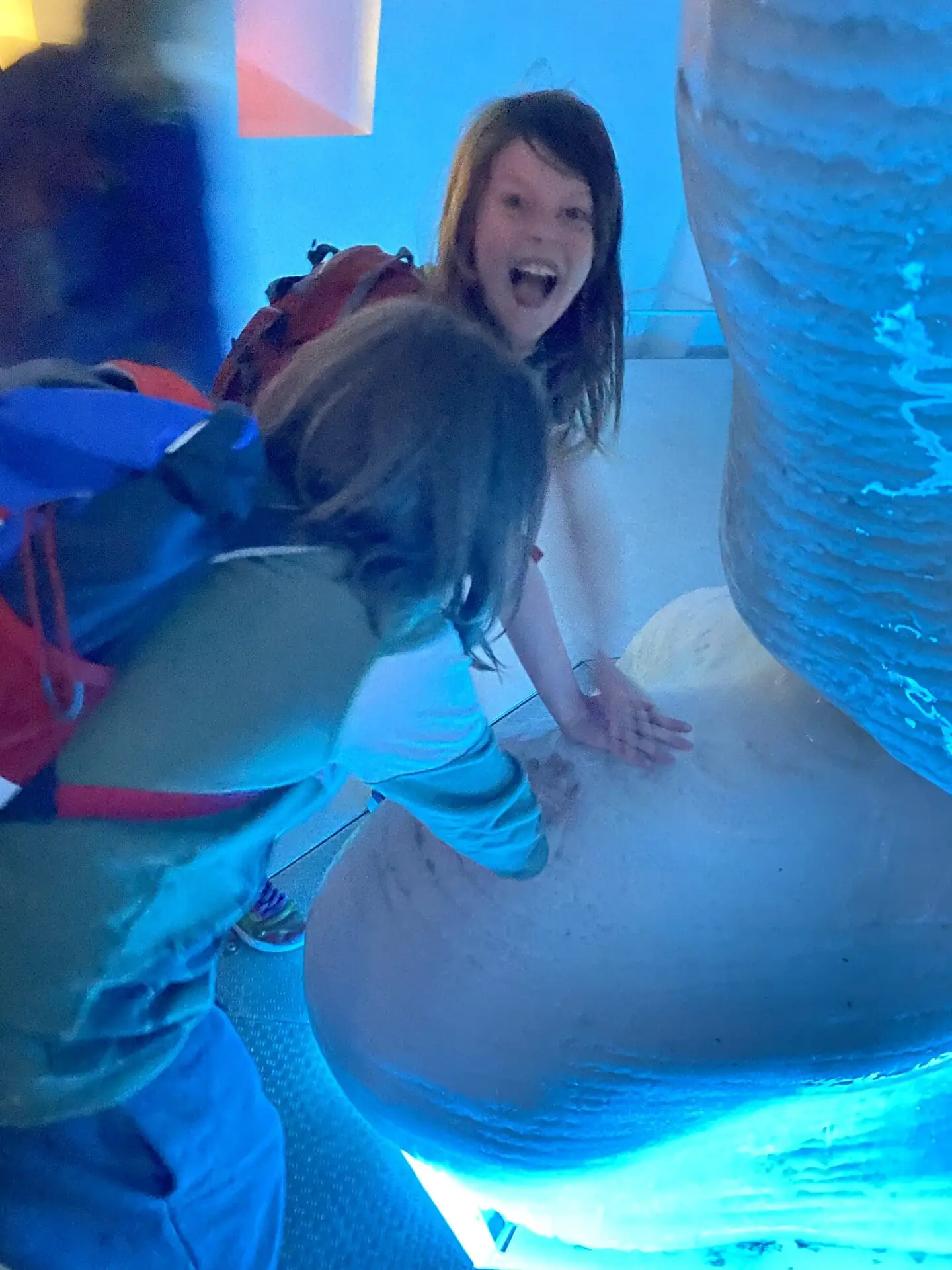 Children touching an iceberg