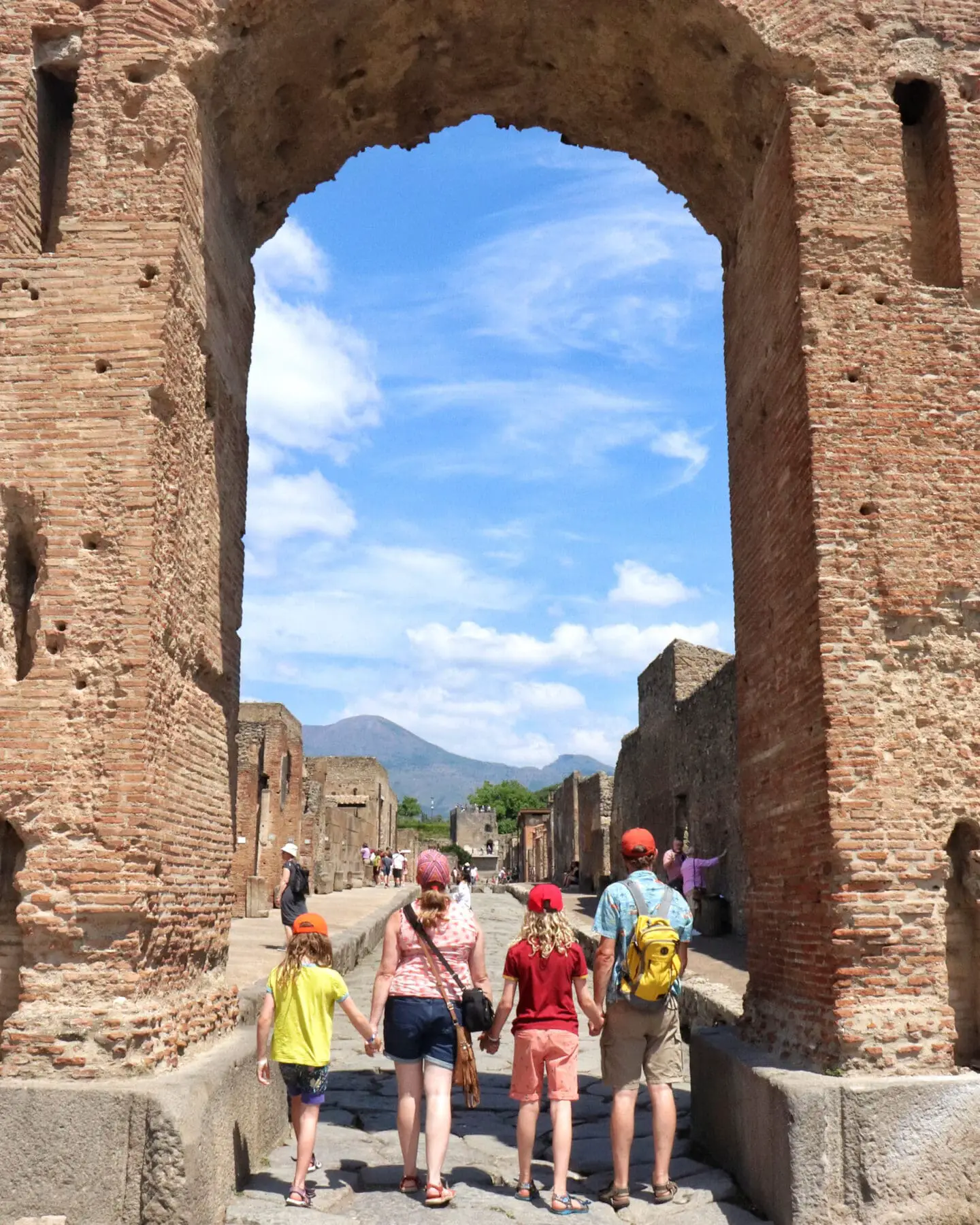 Pompeii family standing in arch