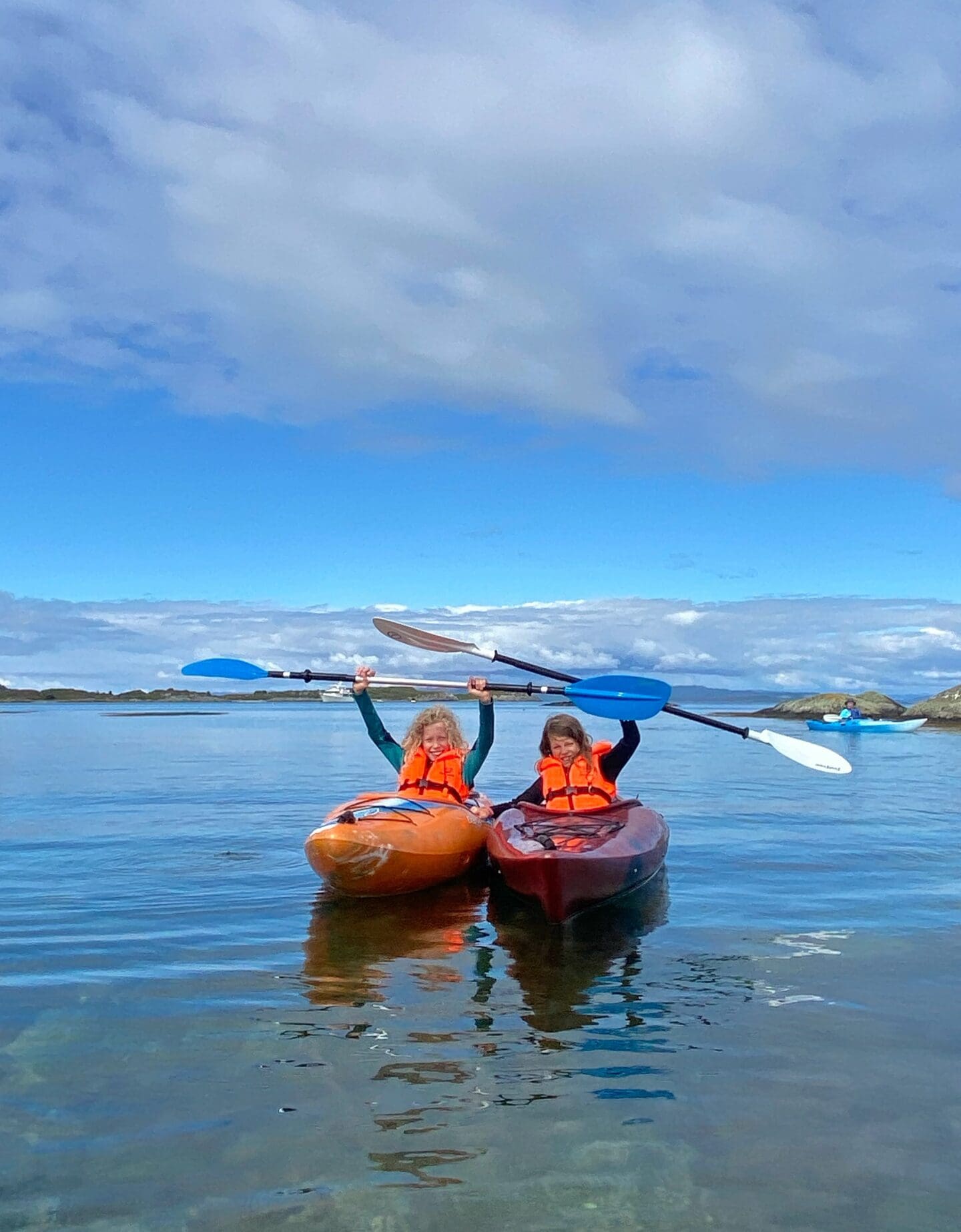 Children in kayaks on west coast of Scotland