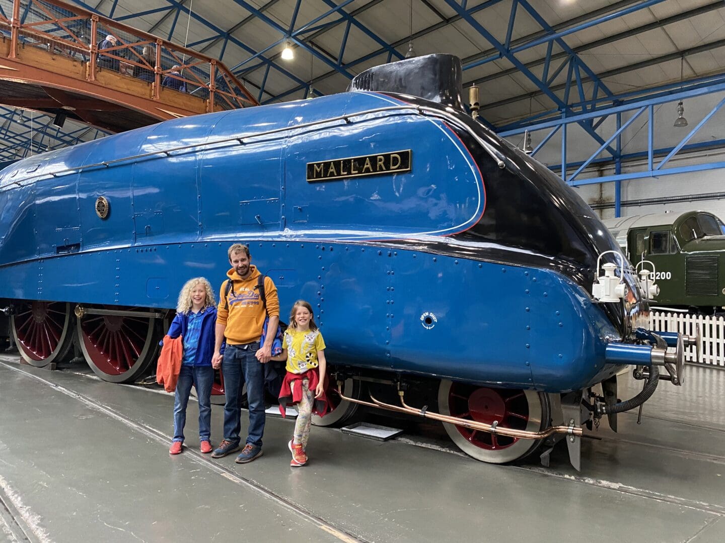 Family in front of the mallard steam train