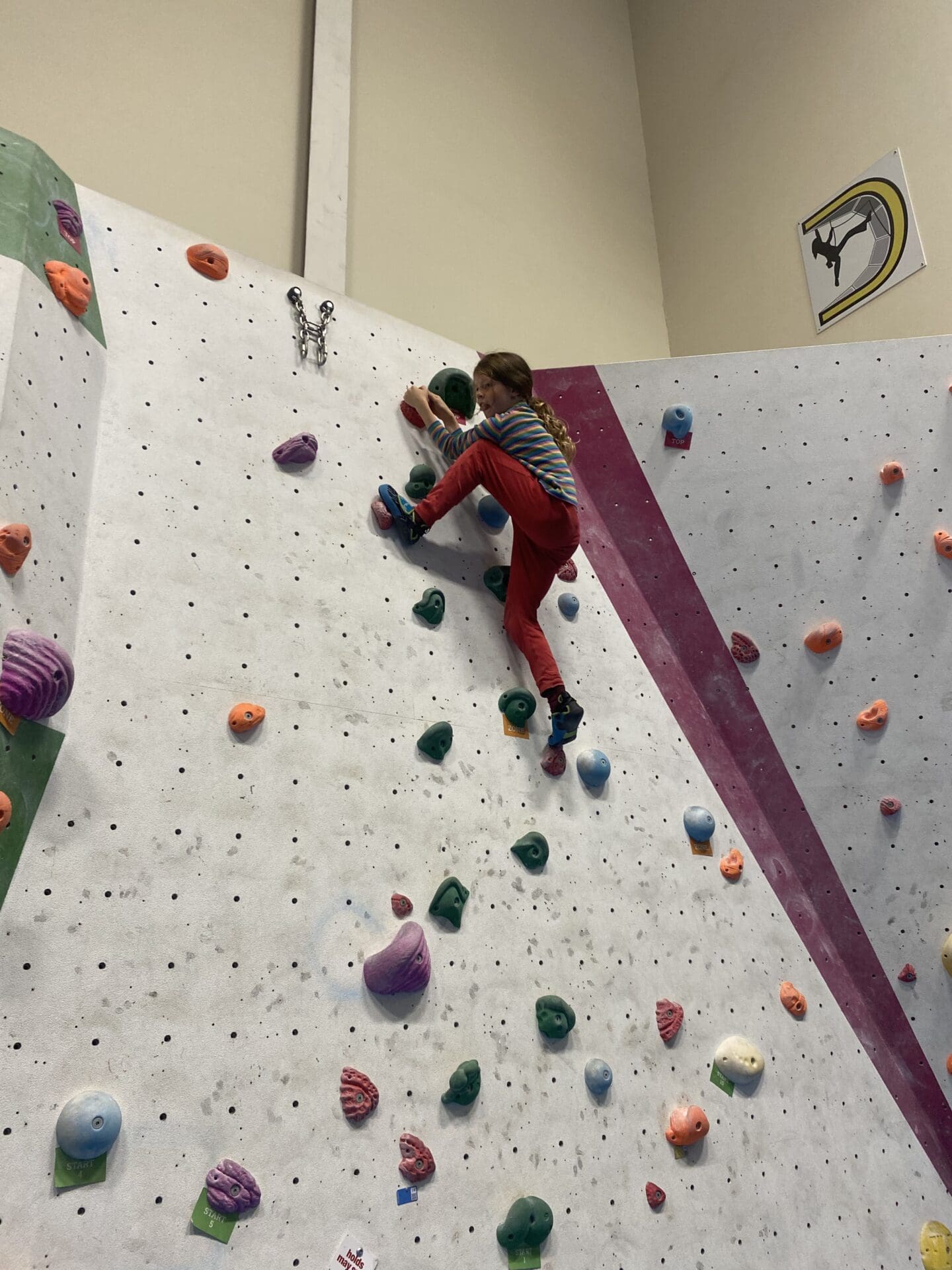 Child climbing on bouldering wall