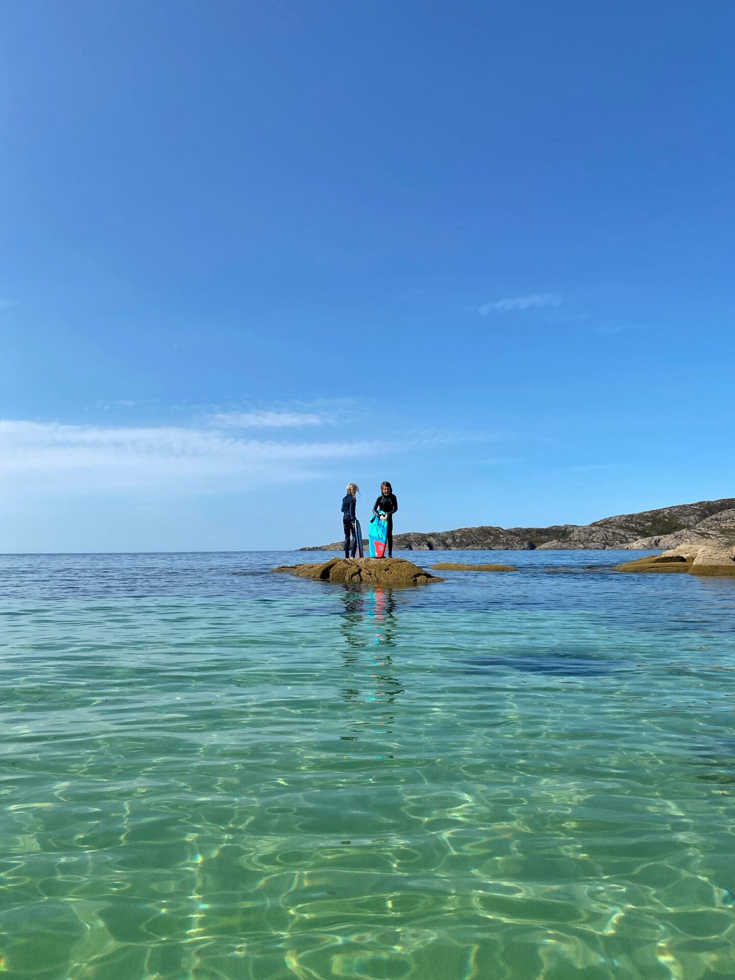 Children on a rock in the sea