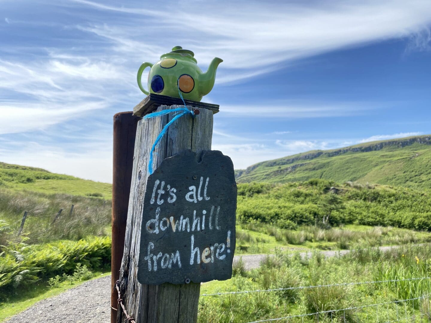 Teapot on a gate post saying ‘it’s all downhill from here’