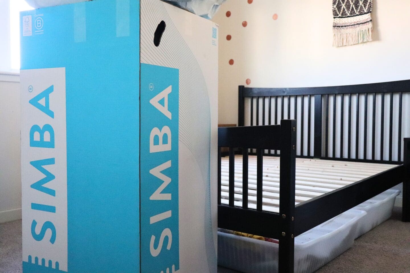 Simba mattress box in front of empty bed and under bed storage