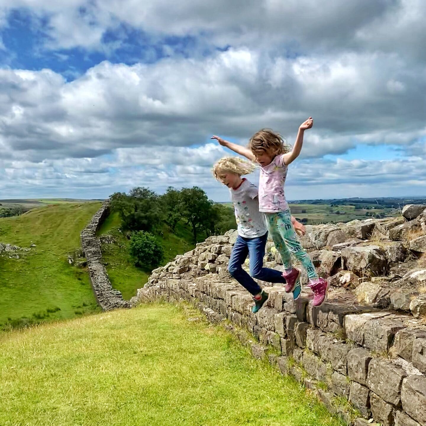 Children jumping off Hadrian’s wall