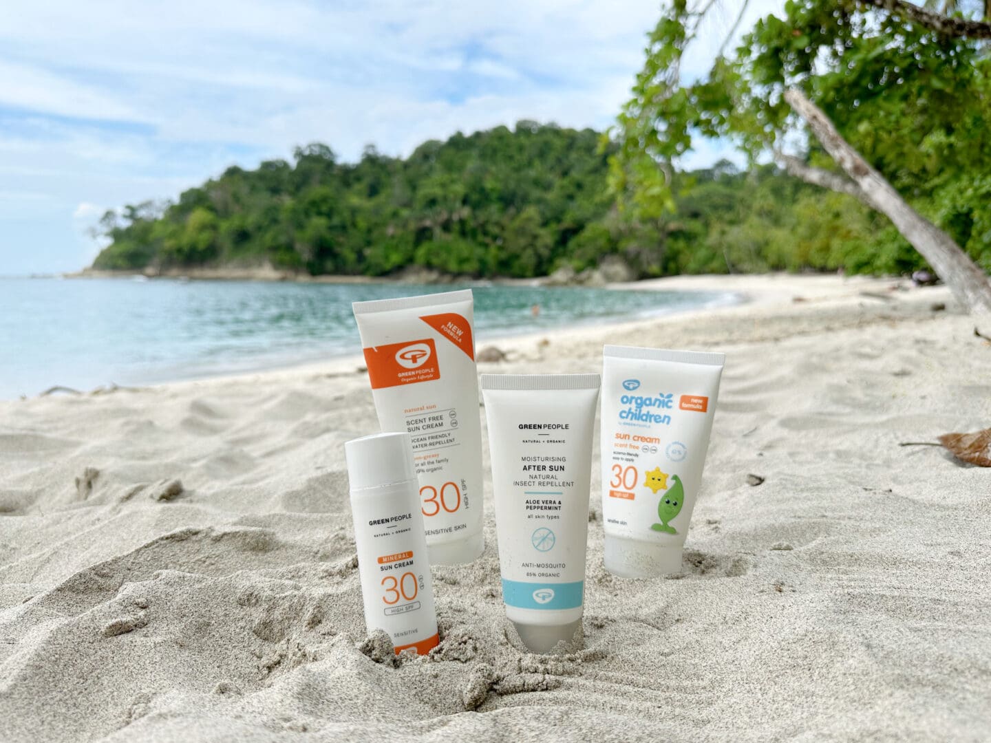 Sun cream on a tropical beach with vegetation and sea